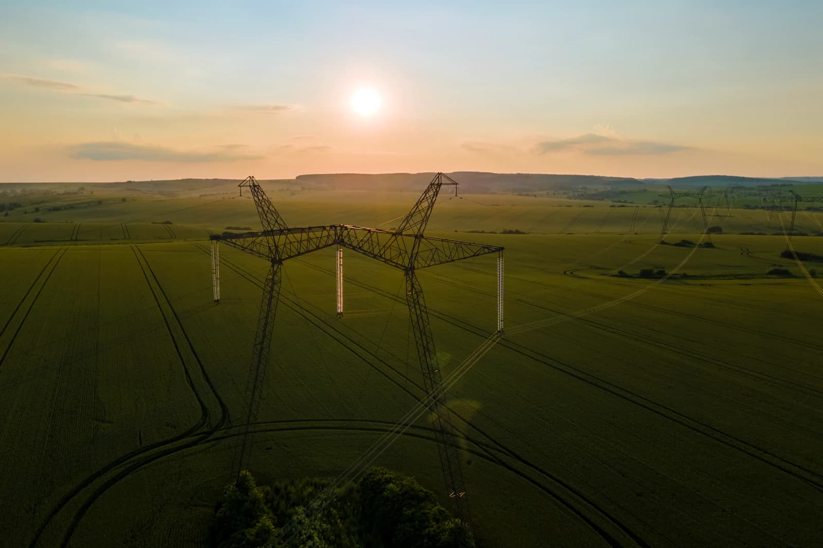 High-voltage transmission towers at dusk